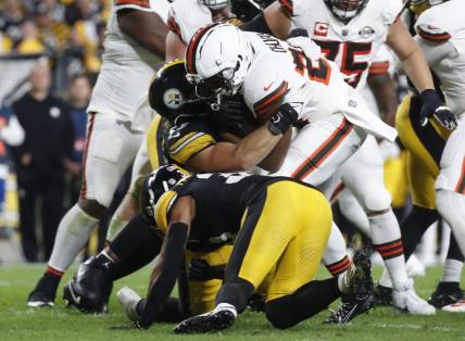 Sep 18, 2023; Pittsburgh, Pennsylvania, USA;  Cleveland Browns running back Nick Chubb (24) is tackled by Pittsburgh Steelers linebacker Cole Holcomb (55) and safety Minkah Fitzpatrick (39) during the second quarter against at Acrisure Stadium. Chubb was injured on the play and taken from the field on a cart. Mandatory Credit: Charles LeClaire-USA TODAY Sports