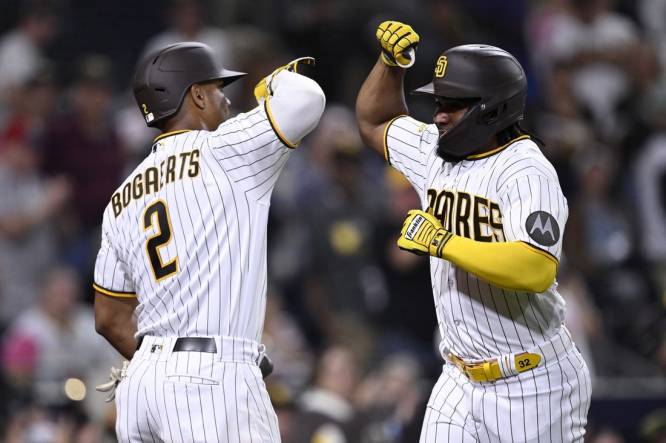 Sep 18, 2023; San Diego, California, USA; San Diego Padres third baseman Eguy Rosario (right) is congratulated by shortstop Xander Bogaerts (2) after hitting a home run against the Colorado Rockies during the third inning at Petco Park. Mandatory Credit: Orlando Ramirez-USA TODAY Sports