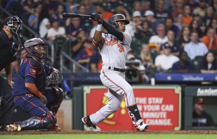 Sep 18, 2023; Houston, Texas, USA; Baltimore Orioles center fielder Cedric Mullins (31) hits a three-run home run during the ninth inning against the Houston Astros at Minute Maid Park. Mandatory Credit: Troy Taormina-USA TODAY Sports