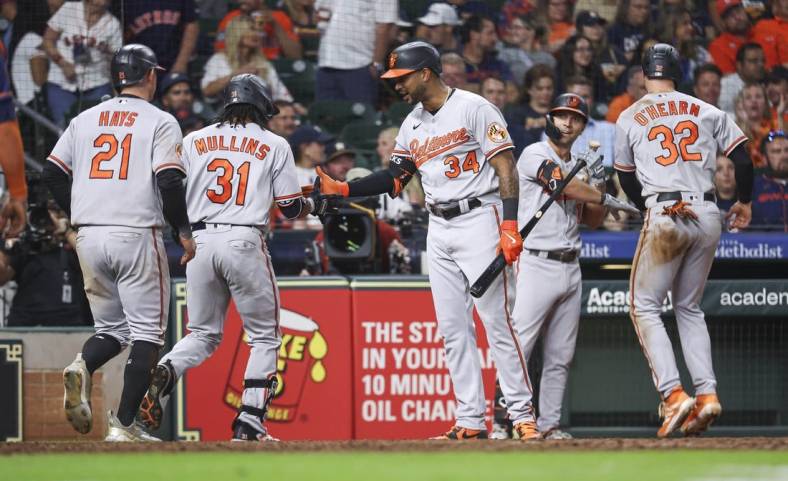Sep 18, 2023; Houston, Texas, USA; Baltimore Orioles center fielder Cedric Mullins (31) celebrates with right fielder Aaron Hicks (34) after hitting a home run during the ninth inning against the Houston Astros at Minute Maid Park. Mandatory Credit: Troy Taormina-USA TODAY Sports