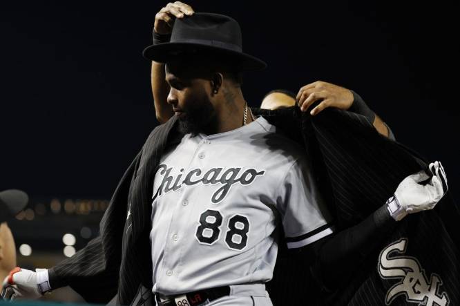 Sep 19, 2023; Washington, District of Columbia, USA; Chicago White Sox center fielder Luis Robert Jr. (88) is given the "Southside Jacket" by White Sox shortstop Elvis Andrus (1) after hitting a home run against the Washington Nationals during the fourth inning at Nationals Park. Mandatory Credit: Geoff Burke-USA TODAY Sports