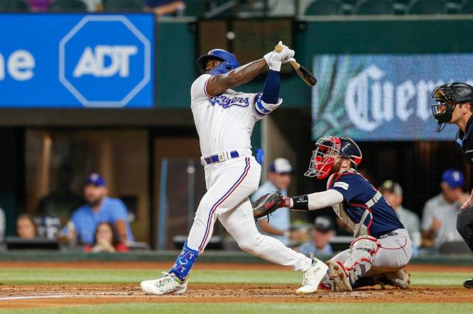 Sep 19, 2023; Arlington, Texas, USA; Texas Rangers right fielder Adolis Garcia hits a home run during the second inning against the Boston Red Sox at Globe Life Field. Mandatory Credit: Andrew Dieb-USA TODAY Sports