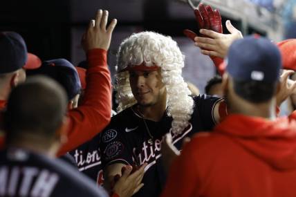 Sep 19, 2023; Washington, District of Columbia, USA; Washington Nationals designated hitter Joey Meneses (45) poses with teammates while wearing the Founding Fathers home run wig after hitting a go ahead three run home run against the Chicago White Sox during the seventh inning at Nationals Park. Mandatory Credit: Geoff Burke-USA TODAY Sports