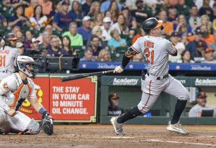 Sep 19, 2023; Houston, Texas, USA; Baltimore Orioles left fielder Austin Hays (21) hits a three run home run against the Houston Astros in the third inning at Minute Maid Park. Mandatory Credit: Thomas Shea-USA TODAY Sports