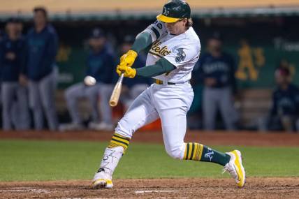 Sep 19, 2023; Oakland, California, USA; Oakland Athletics catcher Shea Langeliers (23) hits a sacrifice fly ball during the seventh inning against the Seattle Mariners at Oakland-Alameda County Coliseum. Mandatory Credit: Neville E. Guard-USA TODAY Sports