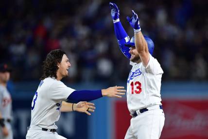 Sep 19, 2023; Los Angeles, California, USA; Los Angeles Dodgers third baseman Max Muncy (13) celebrates with center fielder James Outman (33) after hitting a walk off RBI single against the Detroit Tigers during the ninth inning at Dodger Stadium. Mandatory Credit: Gary A. Vasquez-USA TODAY Sports