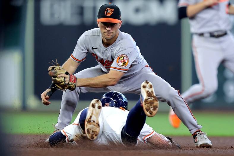 Sep 20, 2023; Houston, Texas, USA; Baltimore Orioles shortstop Gunnar Henderson (2) tags out Houston Astros left fielder Chas McCormick (20) on a stolen base attempt during the third inning at Minute Maid Park. Mandatory Credit: Erik Williams-USA TODAY Sports