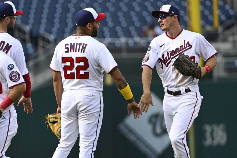 Sep 20, 2023; Washington, District of Columbia, USA; Washington Nationals first baseman Dominic Smith (22) and outfielder Jacob Young (30) celebrate after the game against the Chicago White Sox at Nationals Park. Mandatory Credit: Brad Mills-USA TODAY Sports