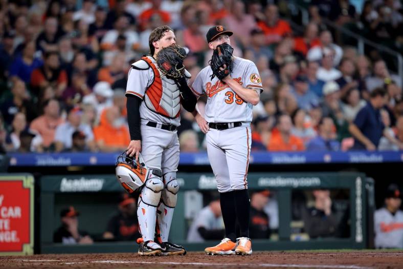 Sep 20, 2023; Houston, Texas, USA; Baltimore Orioles catcher Adley Rutschman (35) talks with Baltimore Orioles starting pitcher Kyle Bradish (39) during an umpire meeting during the sixth inning against the Houston Astros at Minute Maid Park. Mandatory Credit: Erik Williams-USA TODAY Sports