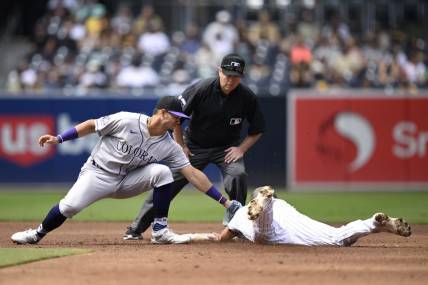Sep 20, 2023; San Diego, California, USA; San Diego Padres second baseman Matthew Batten (right) is tagged out by Colorado Rockies shortstop Ezequiel Tovar (left) attempting to steal second base during the second inning at Petco Park. Mandatory Credit: Orlando Ramirez-USA TODAY Sports