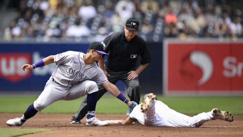 Sep 20, 2023; San Diego, California, USA; San Diego Padres second baseman Matthew Batten (right) is tagged out by Colorado Rockies shortstop Ezequiel Tovar (left) attempting to steal second base during the second inning at Petco Park. Mandatory Credit: Orlando Ramirez-USA TODAY Sports