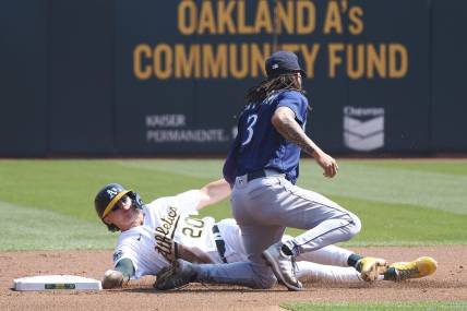 Sep 20, 2023; Oakland, California, USA; Oakland Athletics second baseman Zack Gelof (20) steals second base against Seattle Mariners shortstop J.P. Crawford (3) during the first inning at Oakland-Alameda County Coliseum. Mandatory Credit: Kelley L Cox-USA TODAY Sports