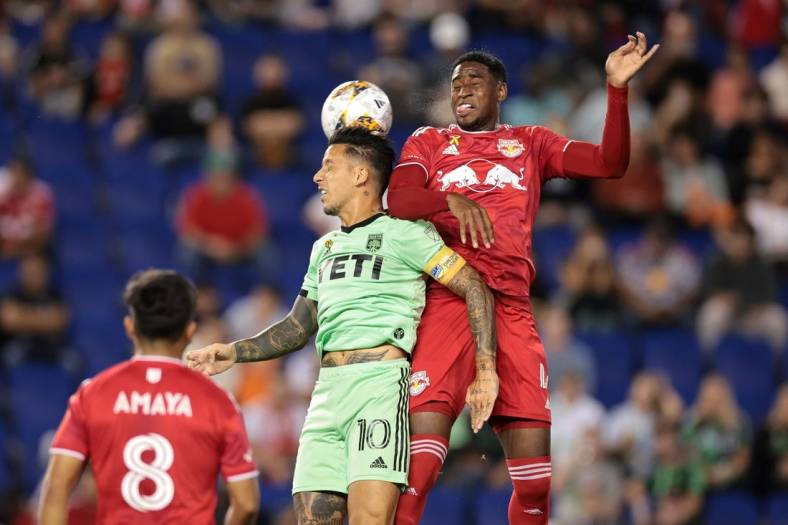 Sep 20, 2023; Harrison, New Jersey, USA; Austin FC forward Sebastian Driussi (10) and New York Red Bulls defender Andres Reyes (4) jump for a header in the first half at Red Bull Arena. Mandatory Credit: Vincent Carchietta-USA TODAY Sports