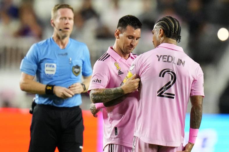 Sep 20, 2023; Fort Lauderdale, Florida, USA; Inter Miami forward Lionel Messi (10) places the captains armband on defender DeAndre Yedlin (2) during the first half at DRV PNK Stadium. Mandatory Credit: Rich Storry-USA TODAY Sports