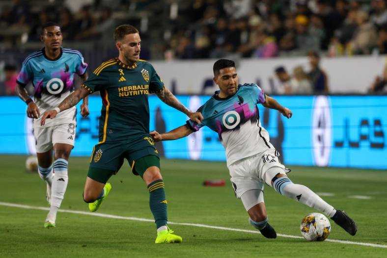 Sep 20, 2023; Carson, California, USA; Minnesota United FC midfielder Emanuel Reynoso (10) fights for the ball during the first half against Los Angeles Galaxy at Dignity Health Sports Park. Mandatory Credit: Kiyoshi Mio-USA TODAY Sports