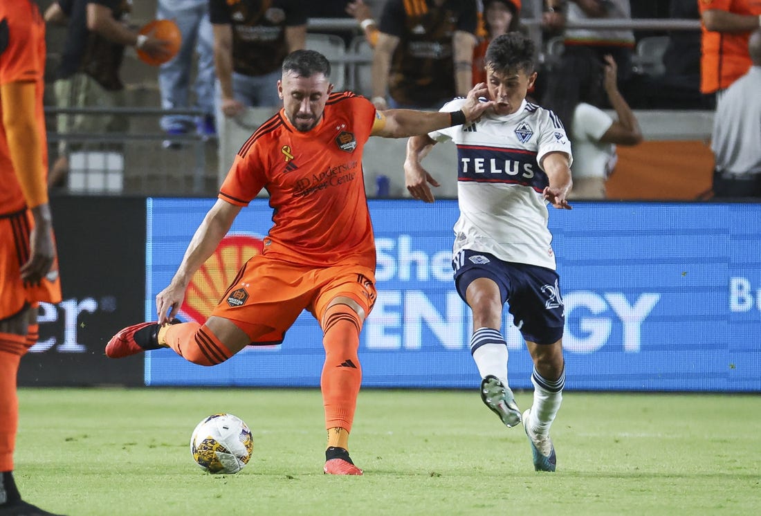 Sep 20, 2023; Houston, Texas, USA; Houston Dynamo FC midfielder Hector Herrera (16) kicks the ball as Vancouver Whitecaps FC midfielder Andres Cubas (20) defends during the first half at Shell Energy Stadium. Mandatory Credit: Troy Taormina-USA TODAY Sports