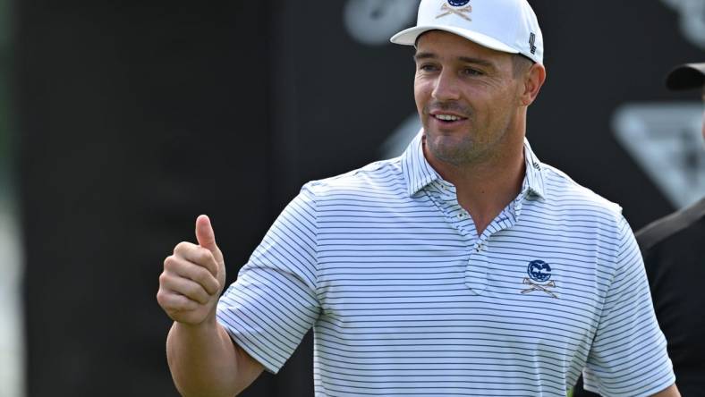 Sep 22, 2023; Sugar Grove, Illinois, USA; Bryson DeChambeau interacts with fans while warming up during the first round of the LIV Golf Chicago golf tournament at Rich Harvest Farms. Mandatory Credit: Jamie Sabau-USA TODAY Sports