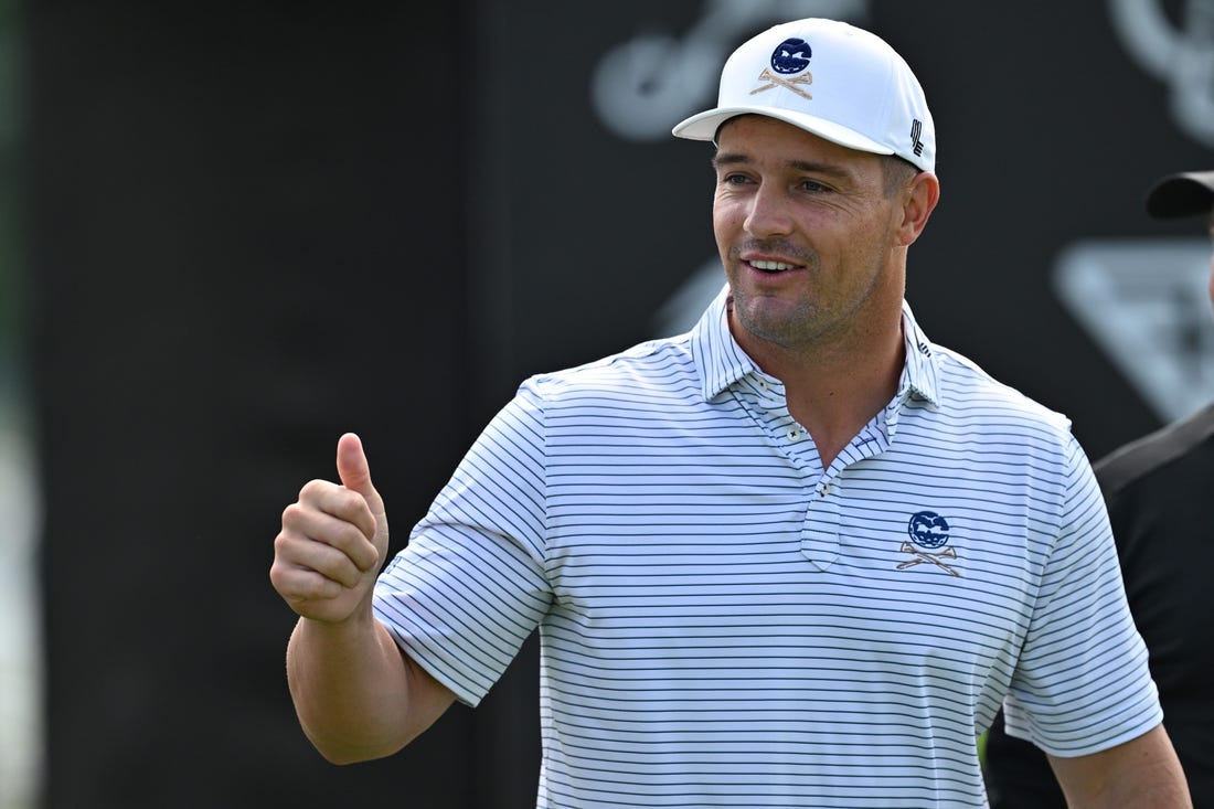 Sep 22, 2023; Sugar Grove, Illinois, USA; Bryson DeChambeau interacts with fans while warming up during the first round of the LIV Golf Chicago golf tournament at Rich Harvest Farms. Mandatory Credit: Jamie Sabau-USA TODAY Sports