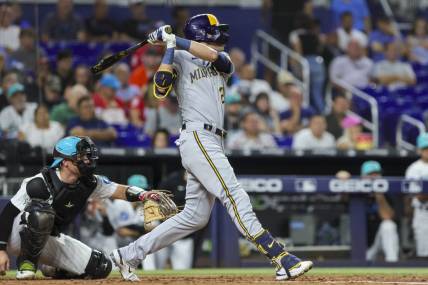 Sep 22, 2023; Miami, Florida, USA; Milwaukee Brewers left fielder Christian Yelich (22) hits a solo home run against the Miami Marlins during the second inning at loanDepot Park. Mandatory Credit: Sam Navarro-USA TODAY Sports