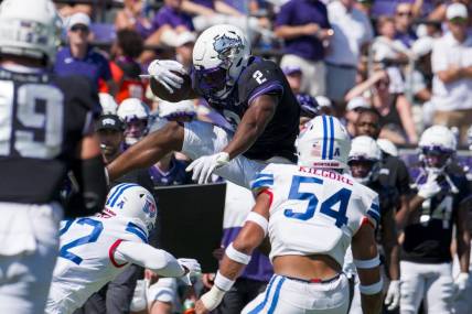 Sep 23, 2023; Fort Worth, Texas, USA; TCU Horned Frogs running back Trey Sanders (2) attempts to leap over SMU Mustangs safety Cale Sanders Jr. (22) during the first half at Amon G. Carter Stadium. Mandatory Credit: Jerome Miron-USA TODAY Sports