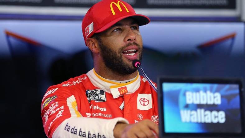 Sep 23, 2023; Fort Worth, Texas, USA;  NASCAR Cup driver Bubba Wallace (23) addresses the media after winning the pole for the Auto Trader EchoPark Automotive 400 at Texas Motor Speedway. Mandatory Credit: Michael C. Johnson-USA TODAY Sports