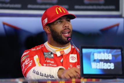 Sep 23, 2023; Fort Worth, Texas, USA;  NASCAR Cup driver Bubba Wallace (23) addresses the media after winning the pole for the Auto Trader EchoPark Automotive 400 at Texas Motor Speedway. Mandatory Credit: Michael C. Johnson-USA TODAY Sports
