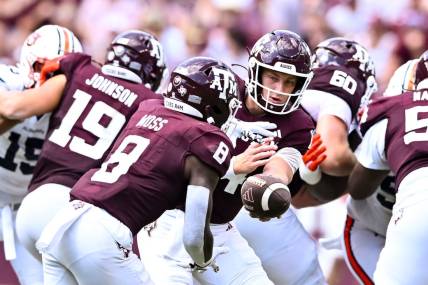 Sep 23, 2023; College Station, Texas, USA; Texas A&M Aggies quarterback Max Johnson (14) hands off the ball to running back Le'Veon Moss (8) during the third quarter against the Auburn Tigers at Kyle Field. Mandatory Credit: Maria Lysaker-USA TODAY Sports