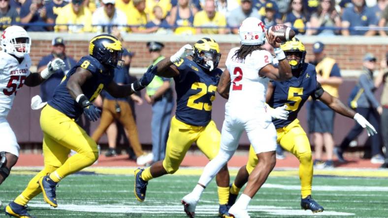 Michigan defenders, from left, Derrick Moore, Michael Barrett and Josaiah Stewart rush against Rutgers quarterback Gavin Wimsatt during the second half of Michigan's 31-7 win on Saturday, Sept. 23 2023, in Ann Arbor.