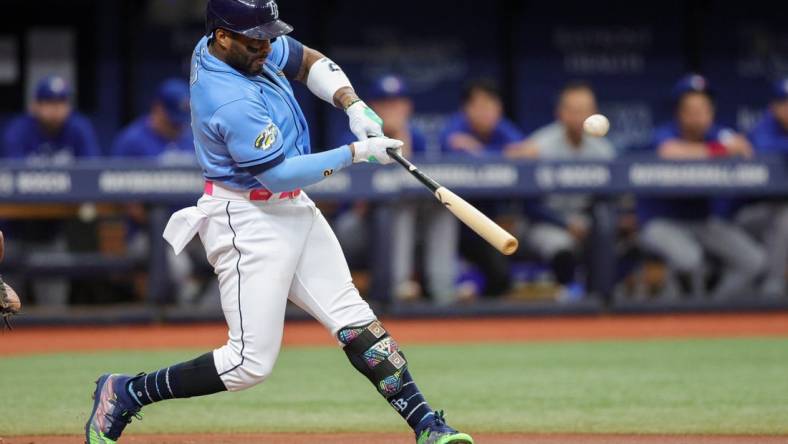 Sep 23, 2023; St. Petersburg, Florida, USA;  Tampa Bay Rays first baseman Yandy Diaz (2) hits a solo home run against the Toronto Blue Jays in the first inning at Tropicana Field. Mandatory Credit: Nathan Ray Seebeck-USA TODAY Sports