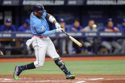 Sep 23, 2023; St. Petersburg, Florida, USA;  Tampa Bay Rays first baseman Yandy Diaz (2) hits a solo home run against the Toronto Blue Jays in the first inning at Tropicana Field. Mandatory Credit: Nathan Ray Seebeck-USA TODAY Sports