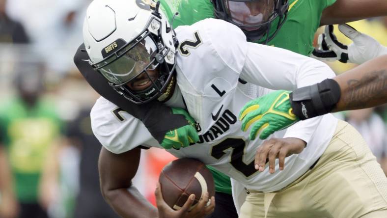 Sep 23, 2023; Eugene, Oregon, USA; Oregon Ducks defensive end Jordan Burch (1) sacks Colorado Buffaloes quarterback Shedeur Sanders (2) during the first half at Autzen Stadium. Mandatory Credit: Soobum Im-USA TODAY Sports