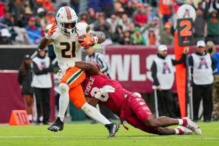 Sep 23, 2023; Philadelphia, Pennsylvania, USA;  Temple Owls safety Alex Odom (8) can   t stop Miami Hurricanes running back Henry Parrish Jr. (21) from scoring a touchdown in the second half against the Temple Owls at Lincoln Financial Field. Mandatory Credit: Andy Lewis-USA TODAY Sports