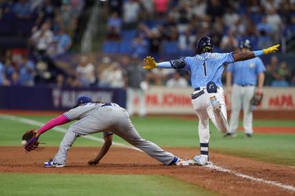 Sep 23, 2023; St. Petersburg, Florida, USA;  Tampa Bay Rays designated hitter Junior Caminero (1) is safe at first after an overturned out call against the Toronto Blue Jays in the ninth inning at Tropicana Field. Mandatory Credit: Nathan Ray Seebeck-USA TODAY Sports