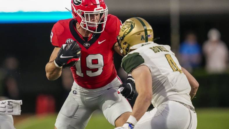 Sep 23, 2023; Athens, Georgia, USA; Georgia Bulldogs tight end Brock Bowers (19) runs against UAB Blazers safety Ike Rowell (4) after a catch during the first quarter at Sanford Stadium. Mandatory Credit: Dale Zanine-USA TODAY Sports