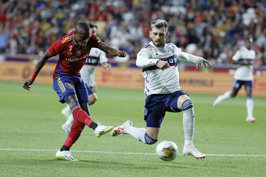 Sep 23, 2023; Sandy, Utah, USA; Real Salt Lake forward Carlos Andres Gomez (11) gets off a shot against Vancouver Whitecaps defender Tristan Blackmon (6) in the first half at America First Field. Mandatory Credit: Jeff Swinger-USA TODAY Sports