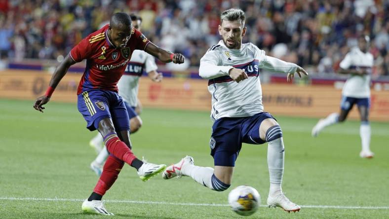 Sep 23, 2023; Sandy, Utah, USA; Real Salt Lake forward Carlos Andres Gomez (11) gets off a shot against Vancouver Whitecaps defender Tristan Blackmon (6) in the first half at America First Field. Mandatory Credit: Jeff Swinger-USA TODAY Sports