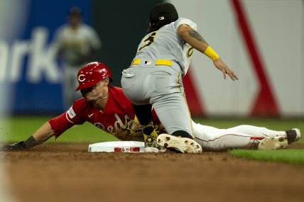 Sep 23, 2023; Cincinnati, Ohio, USA;  Cincinnati Reds center fielder TJ Friedl (29) steals second as Pittsburgh Pirates second baseman Ji Hwan Bae (3) attempts to tag him in the seventh inning at Great American Ball Park. Mandatory Credit: The Cincinnati Enquirer-USA TODAY Sports