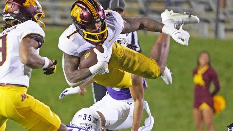 Sep 23, 2023; Evanston, Illinois, USA; Minnesota Golden Gophers running back Darius Taylor (1) leaps over Northwestern Wildcats linebacker Kenny Soares Jr. (35) during the second half at Ryan Field. Mandatory Credit: David Banks-USA TODAY Sports