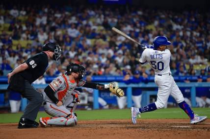 Sep 23, 2023; Los Angeles, California, USA; Los Angeles Dodgers second baseman Mookie Betts (50) hits a two run RBI double against the San Francisco Giants during the eighth inning at Dodger Stadium. Mandatory Credit: Gary A. Vasquez-USA TODAY Sports