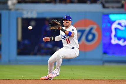 Sep 23, 2023; Los Angeles, California, USA; Los Angeles Dodgers shortstop Miguel Rojas (11) fields the ground ball of San Francisco Giants third baseman J.D. Davis (7) during the ninth inning at Dodger Stadium. Mandatory Credit: Gary A. Vasquez-USA TODAY Sports