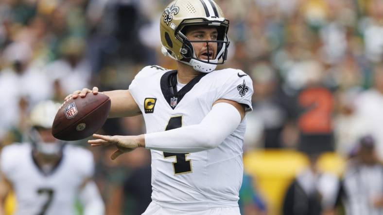 Sep 24, 2023; Green Bay, Wisconsin, USA;  New Orleans Saints quarterback Derek Carr (4) throws a pass during the first quarter against the Green Bay Packers at Lambeau Field. Mandatory Credit: Jeff Hanisch-USA TODAY Sports