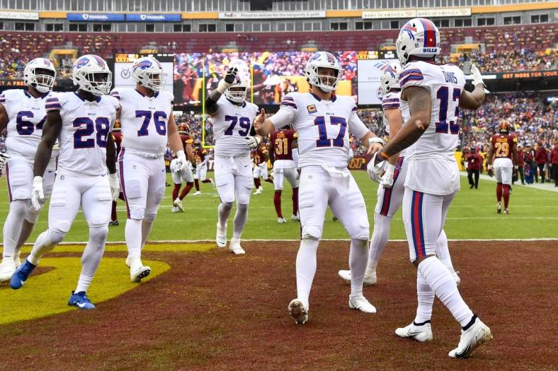 Sep 24, 2023; Landover, Maryland, USA; Buffalo Bills wide receiver Gabe Davis (13) is congratulated by quarterback Josh Allen (17) after scoring a touchdown  during the first half at FedExField. Mandatory Credit: Brad Mills-USA TODAY Sports