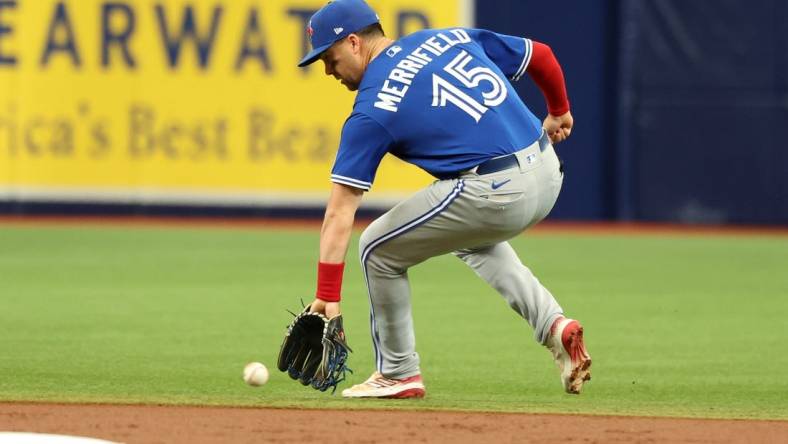 Sep 24, 2023; St. Petersburg, Florida, USA; Toronto Blue Jays second baseman Whit Merrifield (15) fields the ball against the Tampa Bay Rays during the first inning   at Tropicana Field. Mandatory Credit: Kim Klement Neitzel-USA TODAY Sports