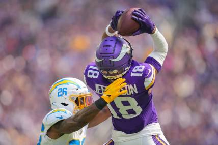 Sep 24, 2023; Minneapolis, Minnesota, USA; Minnesota Vikings wide receiver Justin Jefferson (18) catches a pass against the Los Angeles Chargers cornerback Asante Samuel Jr. (26) in the second quarter at U.S. Bank Stadium. Mandatory Credit: Brad Rempel-USA TODAY Sports