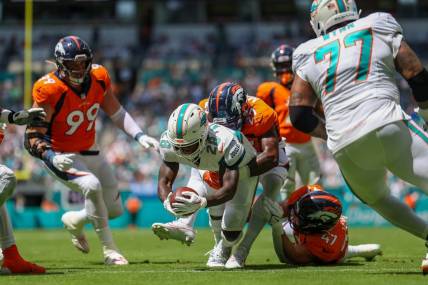 Sep 24, 2023; Miami Gardens, Florida, USA;  Miami Dolphins running back De'Von Achane (28) scores a touchdown  against the Denver Broncos in the first quarter at Hard Rock Stadium. Mandatory Credit: Nathan Ray Seebeck-USA TODAY Sports