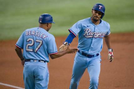 Sep 24, 2023; Arlington, Texas, USA; Texas Rangers second baseman Marcus Semien (2) rounds the bases past third base coach Tony Beasley (27) after Semien hits a lead off home run against the Seattle Mariners during the first inning at Globe Life Field. Mandatory Credit: Jerome Miron-USA TODAY Sports