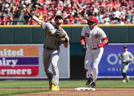 Sep 24, 2023; Cincinnati, Ohio, USA; Cincinnati Reds center fielder TJ Friedl (29) is forced out at second as Pittsburgh Pirates second baseman Jared Triolo (19) throws to first during the first inning at Great American Ball Park. Mandatory Credit: David Kohl-USA TODAY Sports