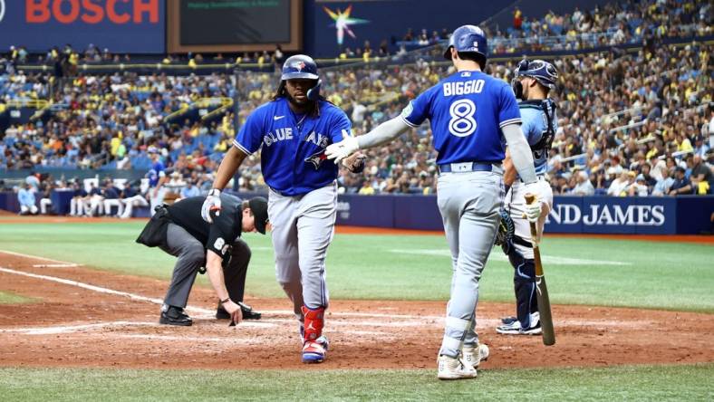 Sep 24, 2023; St. Petersburg, Florida, USA; Toronto Blue Jays first baseman Vladimir Guerrero Jr. (27) is congratulated by second baseman Cavan Biggio (8) after he hit a home run against the Tampa Bay Rays during the sixth inning at Tropicana Field. Mandatory Credit: Kim Klement Neitzel-USA TODAY Sports