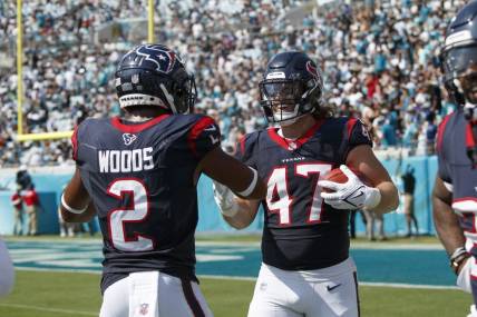 Sep 24, 2023; Jacksonville, Florida, USA; Houston Texans fullback Andrew Beck (47) celebrates a touchdown off of a return kick with wide receiver Robert Woods (2) against the Jacksonville Jaguars during the third quarter at EverBank Stadium. Mandatory Credit: Morgan Tencza-USA TODAY Sports