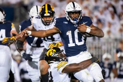 Iowa linebacker Jay Higgins tackles Penn State running back Nick Singleton near the line of scrimmage during the White Out game at Beaver Stadium Saturday, Sept. 23, 2023, in State College, Pa.